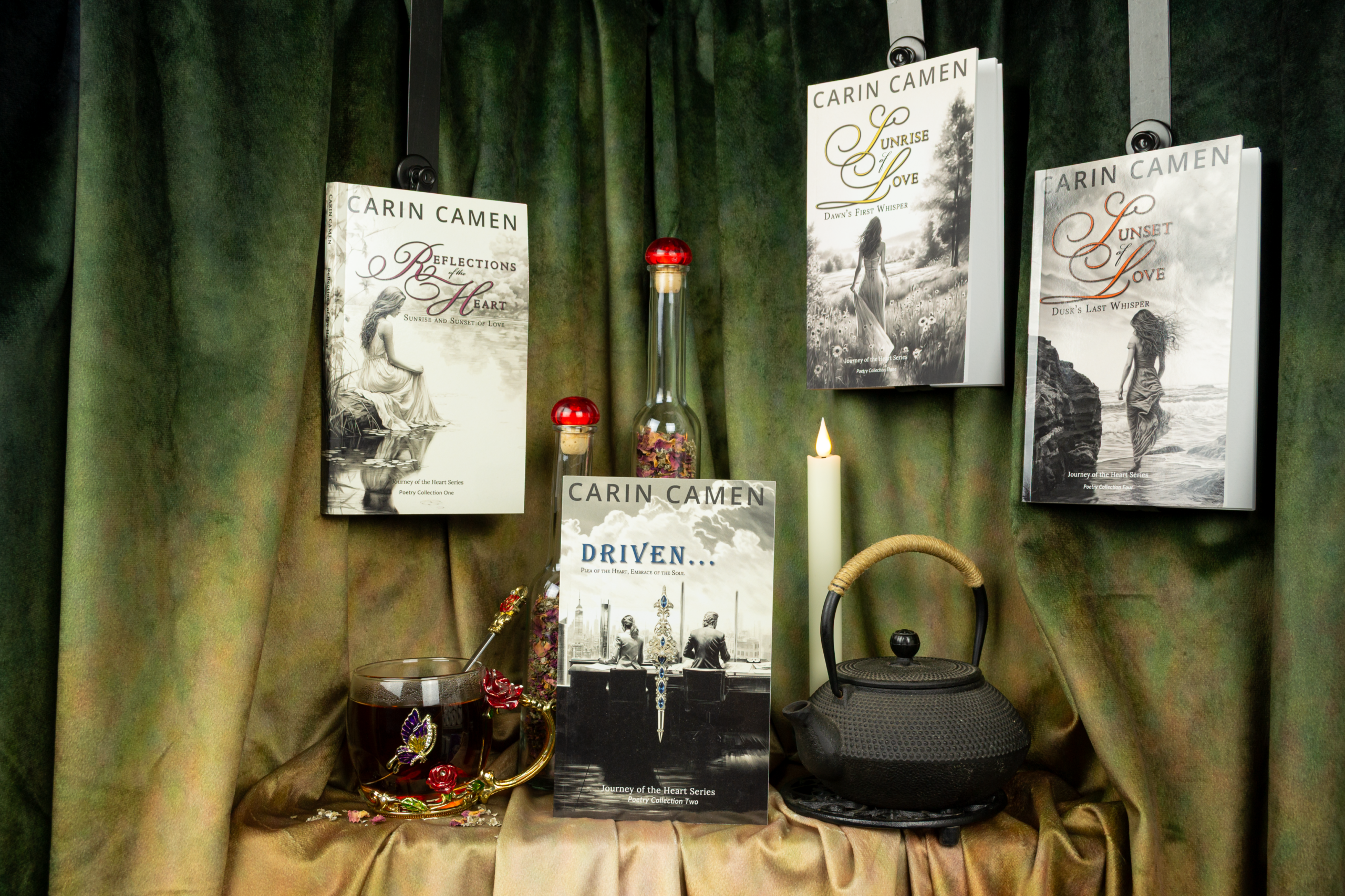 Journey of the Heart poetry series by Carin Camen displayed with tea, a candle, and dried flowers